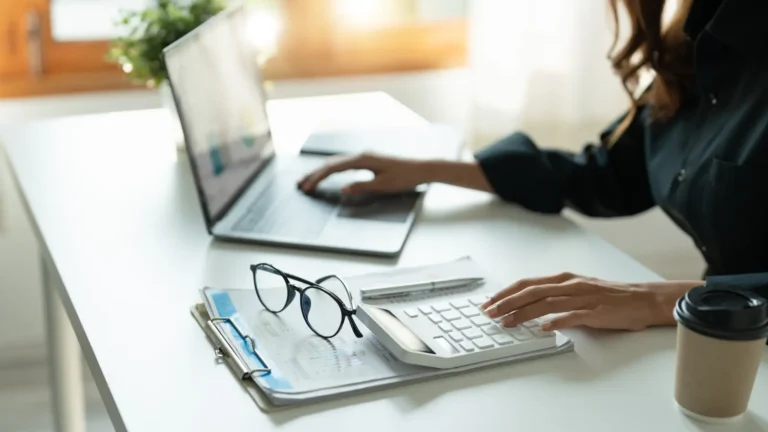 woman looking at investments on her laptop